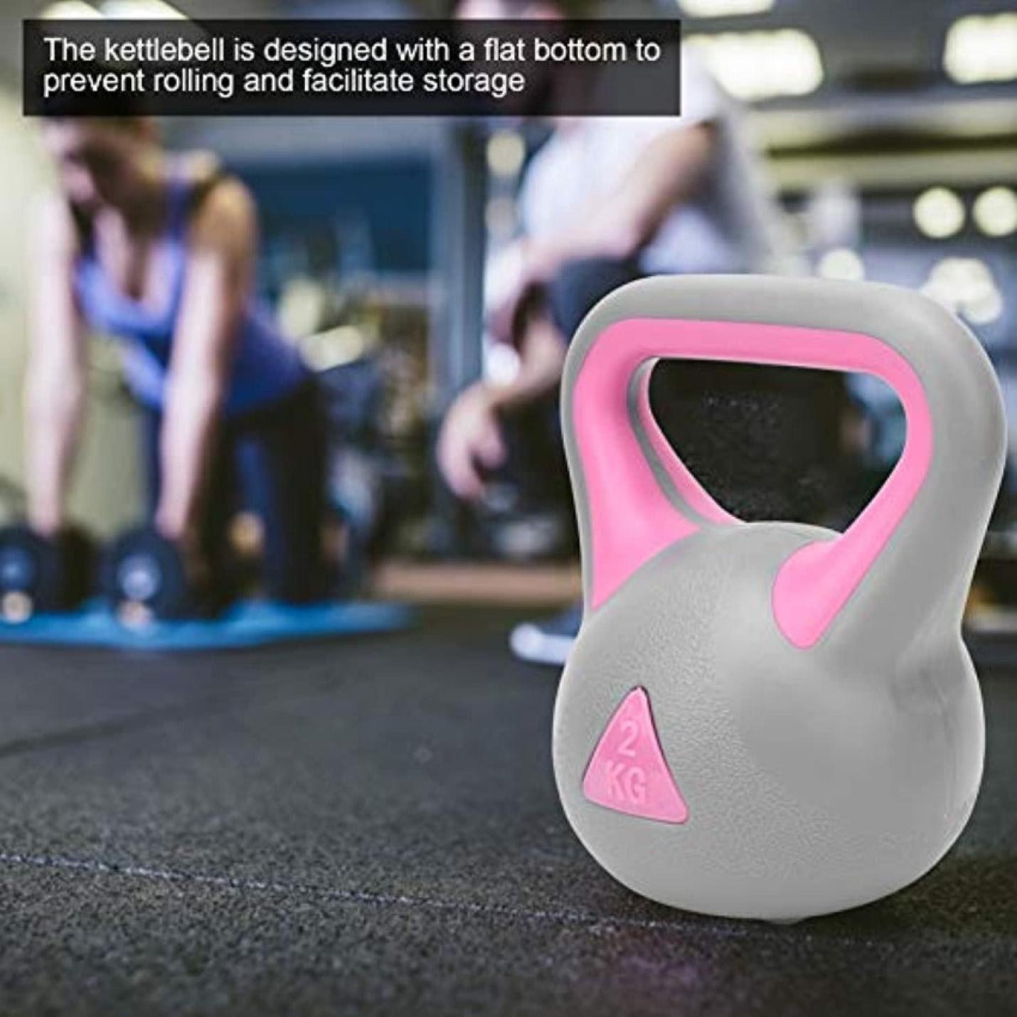 Een Ontdek de kracht van kettlebell oefeningen met deze 2KG kettlebell, perfect voor full-body workouts en vetverbranding, staat met een platte bodem op de voorgrond van een sportschool, met vage individuen die op de achtergrond aan het trainen zijn.